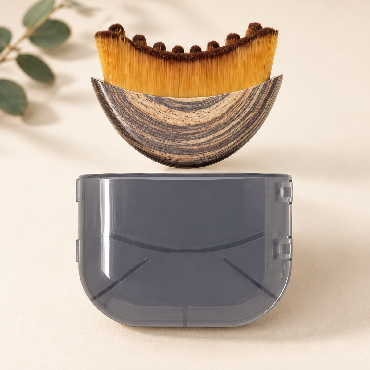 Wakely De-Puff Face Brush with its protective case on a cream surface